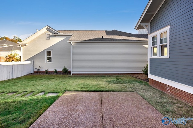 exterior space with a patio area and a lawn