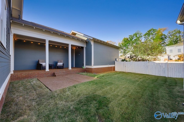view of yard featuring fence and a patio