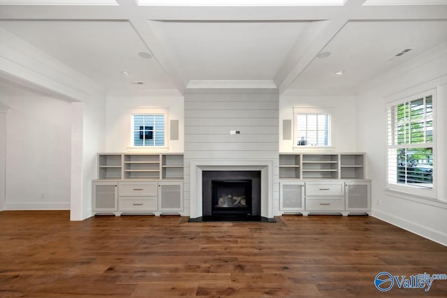 unfurnished living room with crown molding, dark wood-type flooring, baseboards, and a fireplace with flush hearth