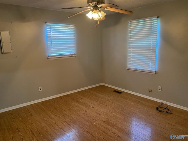 1520 Balch Rd, Madison, AL 35757 - spare room with a ceiling fan, wood finished floors, baseboards, electric panel, and a textured ceiling