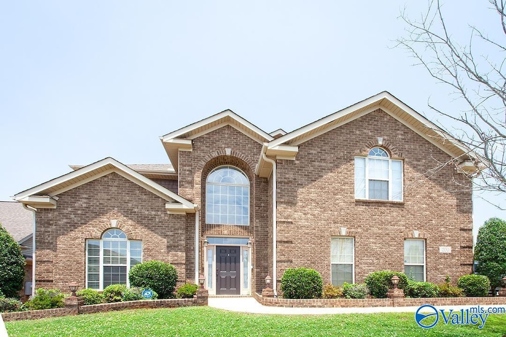 200 Skehan St SW, Huntsville, AL 35824 - traditional-style house featuring a front lawn and brick siding