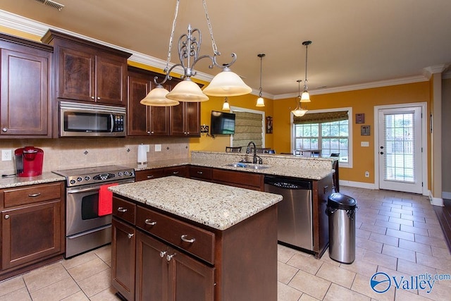 kitchen featuring a kitchen island, decorative backsplash, stainless steel appliances, sink, and kitchen peninsula