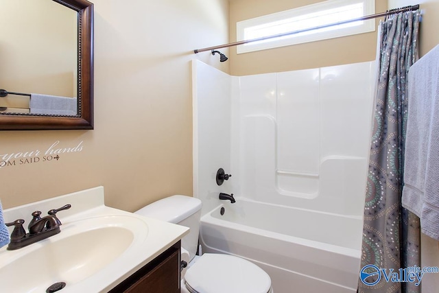 full bathroom featuring shower / bath combination with curtain, vanity, and toilet