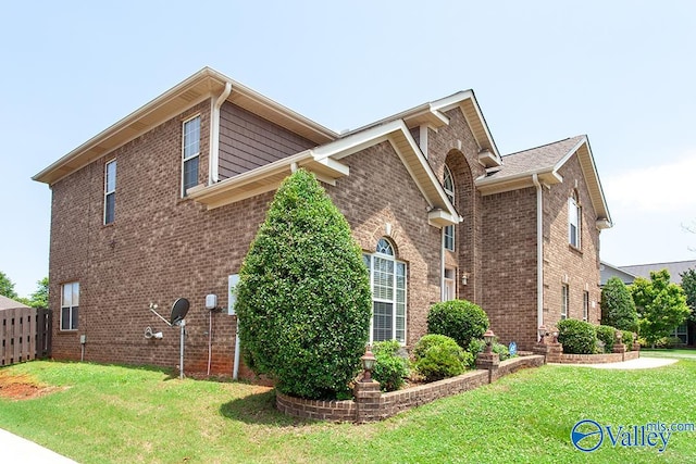 view of side of home featuring a yard