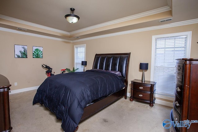 carpeted bedroom with multiple windows, crown molding, and a tray ceiling