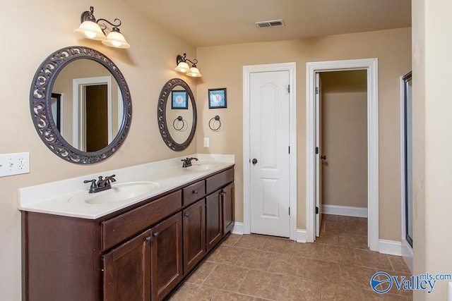 bathroom with an enclosed shower, tile patterned floors, and vanity