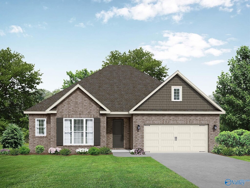 view of front of house with concrete driveway, a front yard, brick siding, a garage, and a shingled roof