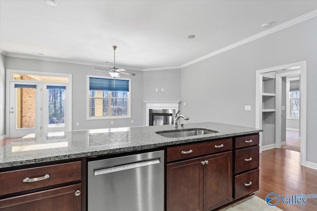 kitchen featuring dishwasher, sink, ornamental molding, light stone counters, and dark brown cabinets