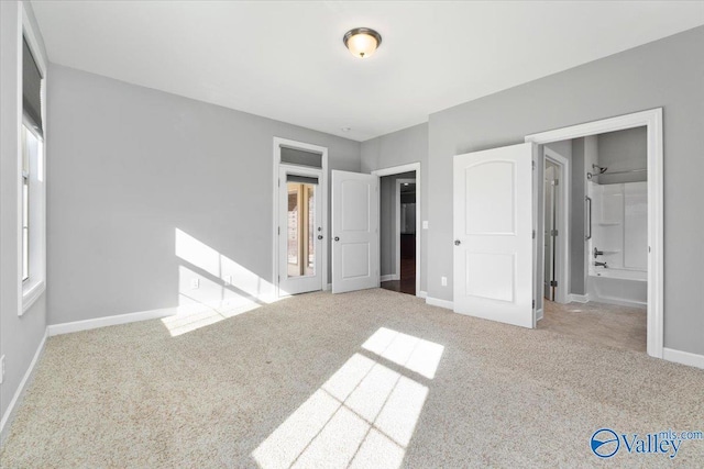 unfurnished bedroom featuring light carpet