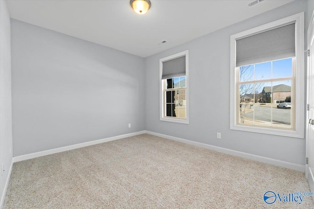 unfurnished room featuring light carpet