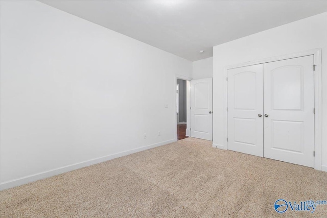 unfurnished bedroom featuring carpet and a closet