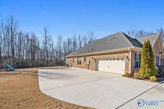 view of property exterior featuring a garage and a playground