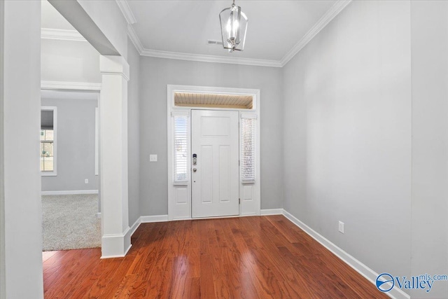 entryway featuring crown molding, a chandelier, and hardwood / wood-style flooring