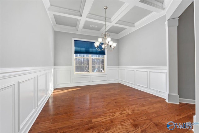 unfurnished dining area with an inviting chandelier, coffered ceiling, dark hardwood / wood-style floors, and beamed ceiling