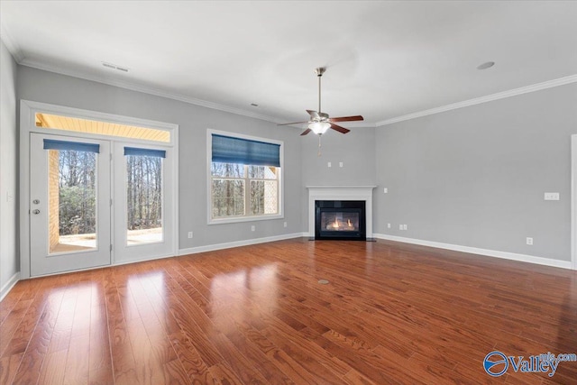 unfurnished living room with hardwood / wood-style flooring, ornamental molding, and ceiling fan