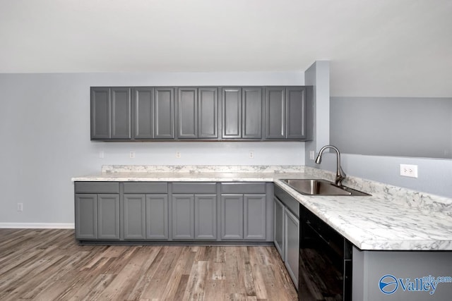 kitchen featuring sink, kitchen peninsula, gray cabinets, and dark hardwood / wood-style flooring