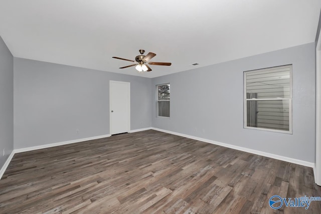 spare room with ceiling fan and dark wood-type flooring