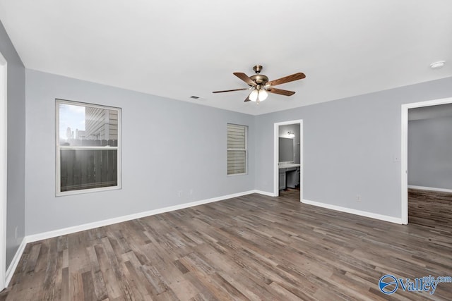 empty room featuring ceiling fan and dark hardwood / wood-style flooring