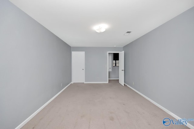 spare room with light carpet