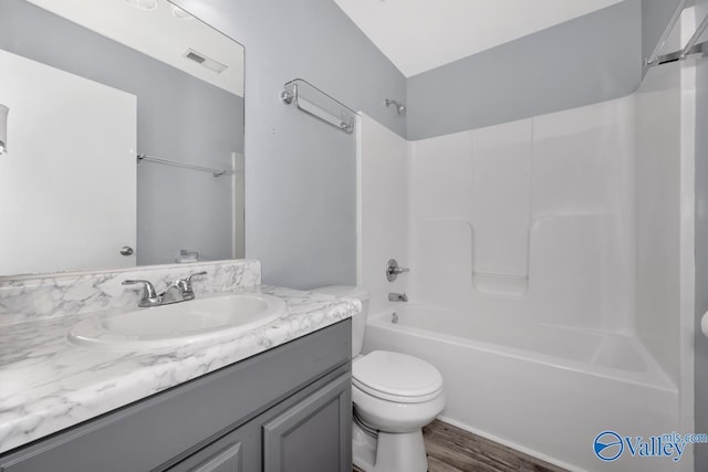 full bathroom featuring shower / bathing tub combination, vanity, toilet, and hardwood / wood-style floors