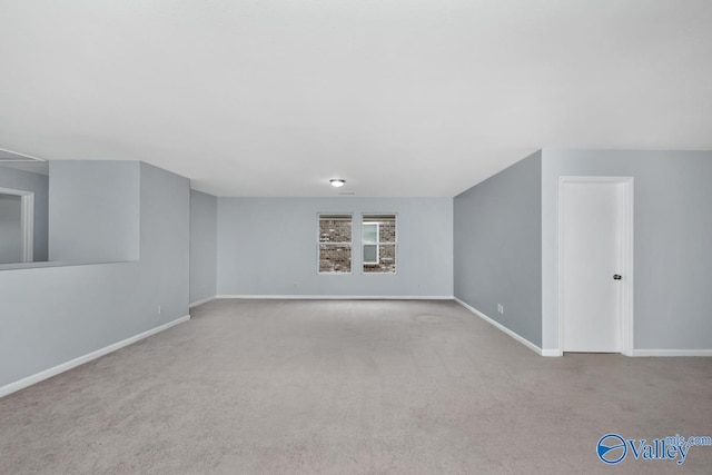 unfurnished room featuring light colored carpet