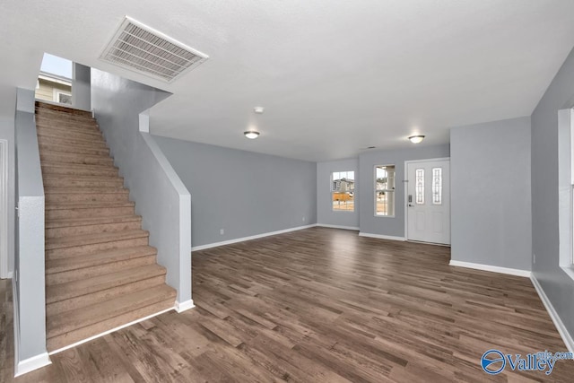 foyer entrance with dark hardwood / wood-style floors