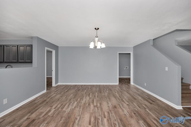 unfurnished dining area with dark wood-type flooring and a chandelier