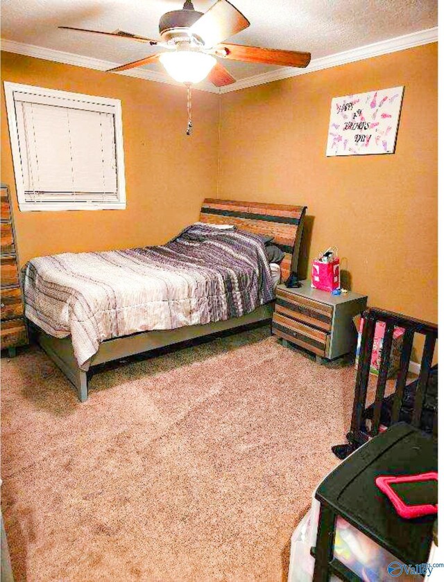 bedroom featuring a ceiling fan, carpet flooring, and ornamental molding