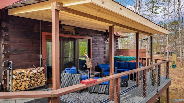 wooden terrace featuring a ceiling fan and fence