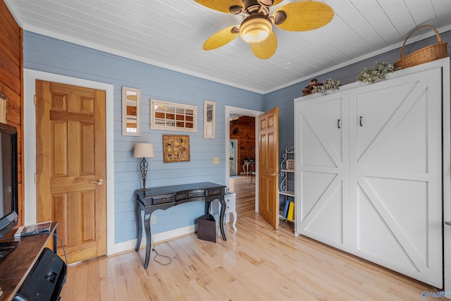 foyer entrance with baseboards, light wood-style flooring, wood ceiling, and a ceiling fan