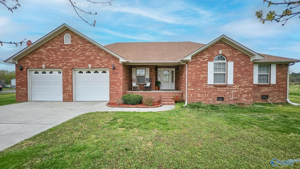 18796 Lydia Corey Rd, Athens, AL 35614 - ranch-style house with a garage, concrete driveway, a front yard, brick siding, and a porch