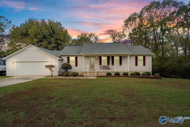 single story home with a yard, covered porch, and a garage