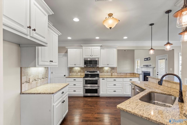 17259 Obsidian Cir, Athens, AL 35613 - kitchen featuring stainless steel appliances, a sink, ornamental molding, backsplash, and white cabinetry