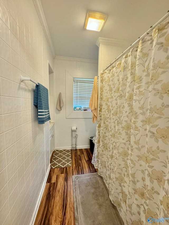 bathroom with hardwood / wood-style flooring and crown molding