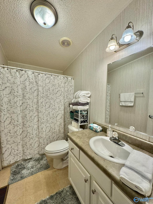 bathroom with curtained shower, tile patterned flooring, toilet, vanity, and a textured ceiling