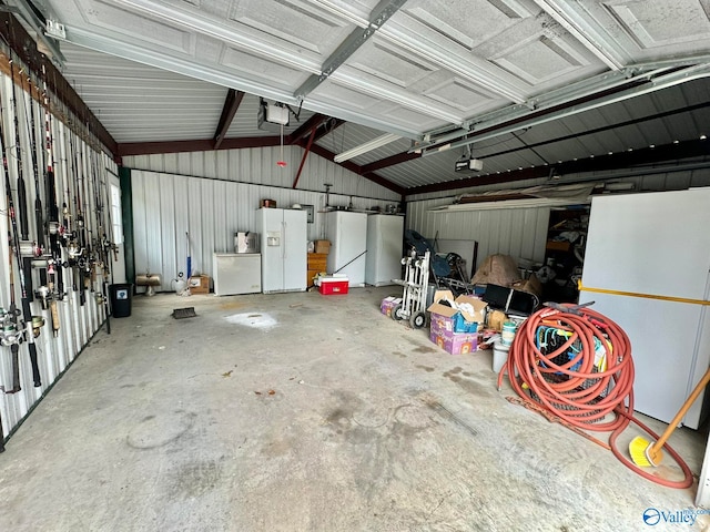 garage featuring a garage door opener and white refrigerator with ice dispenser