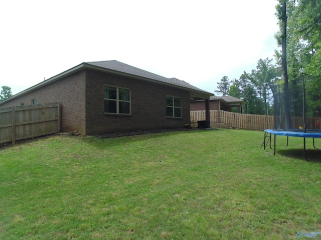 110 Oak Path Ln, Harvest, AL 35749 - back of property with a trampoline and brick siding