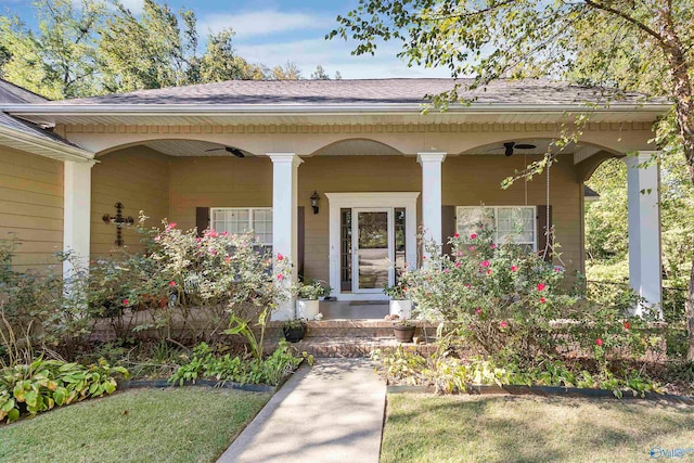 view of exterior entry with a porch and ceiling fan