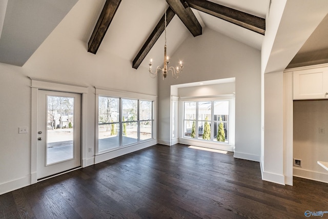 unfurnished living room with dark wood finished floors, high vaulted ceiling, a chandelier, beamed ceiling, and baseboards