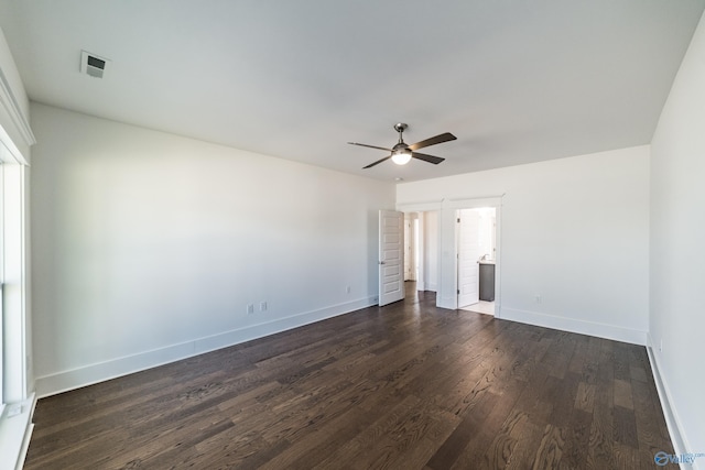 unfurnished bedroom featuring visible vents, baseboards, a ceiling fan, connected bathroom, and dark wood-style flooring