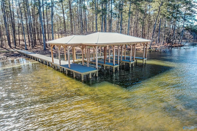 dock area with a water view and boat lift