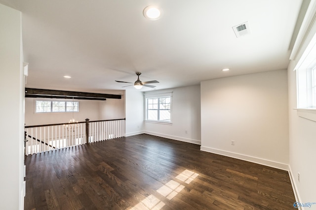 spare room with recessed lighting, ceiling fan with notable chandelier, dark wood-type flooring, visible vents, and baseboards