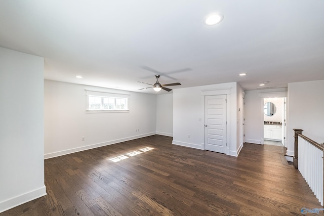 unfurnished living room featuring dark wood-style flooring, recessed lighting, and baseboards