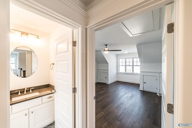 bathroom with wood finished floors, vanity, and baseboards