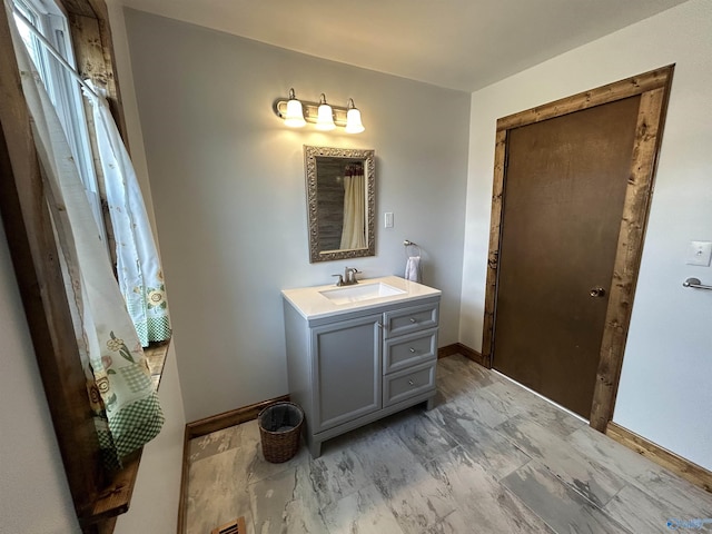 bathroom featuring vanity and baseboards