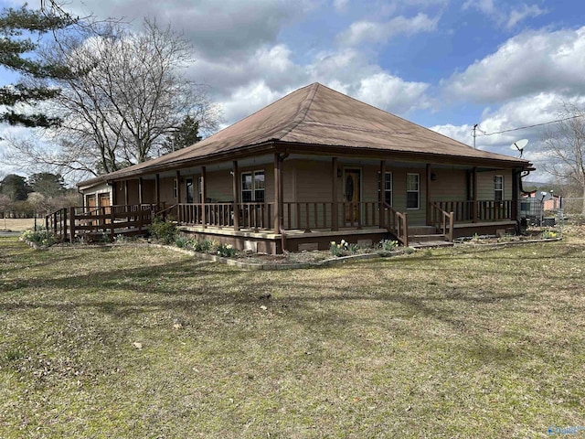 exterior space featuring covered porch and a front yard