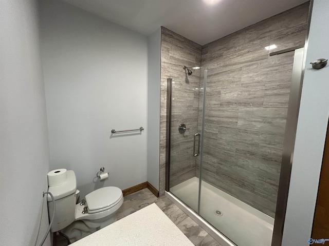 full bathroom with marble finish floor, baseboards, a shower stall, and toilet