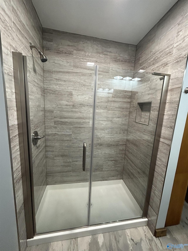 full bath featuring a shower stall