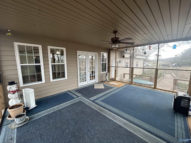 unfurnished sunroom with plenty of natural light, ceiling fan, and wooden ceiling