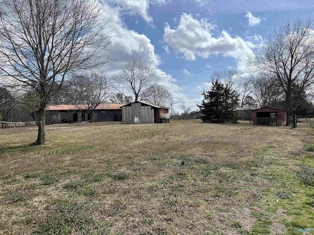 view of yard with an outbuilding and a barn